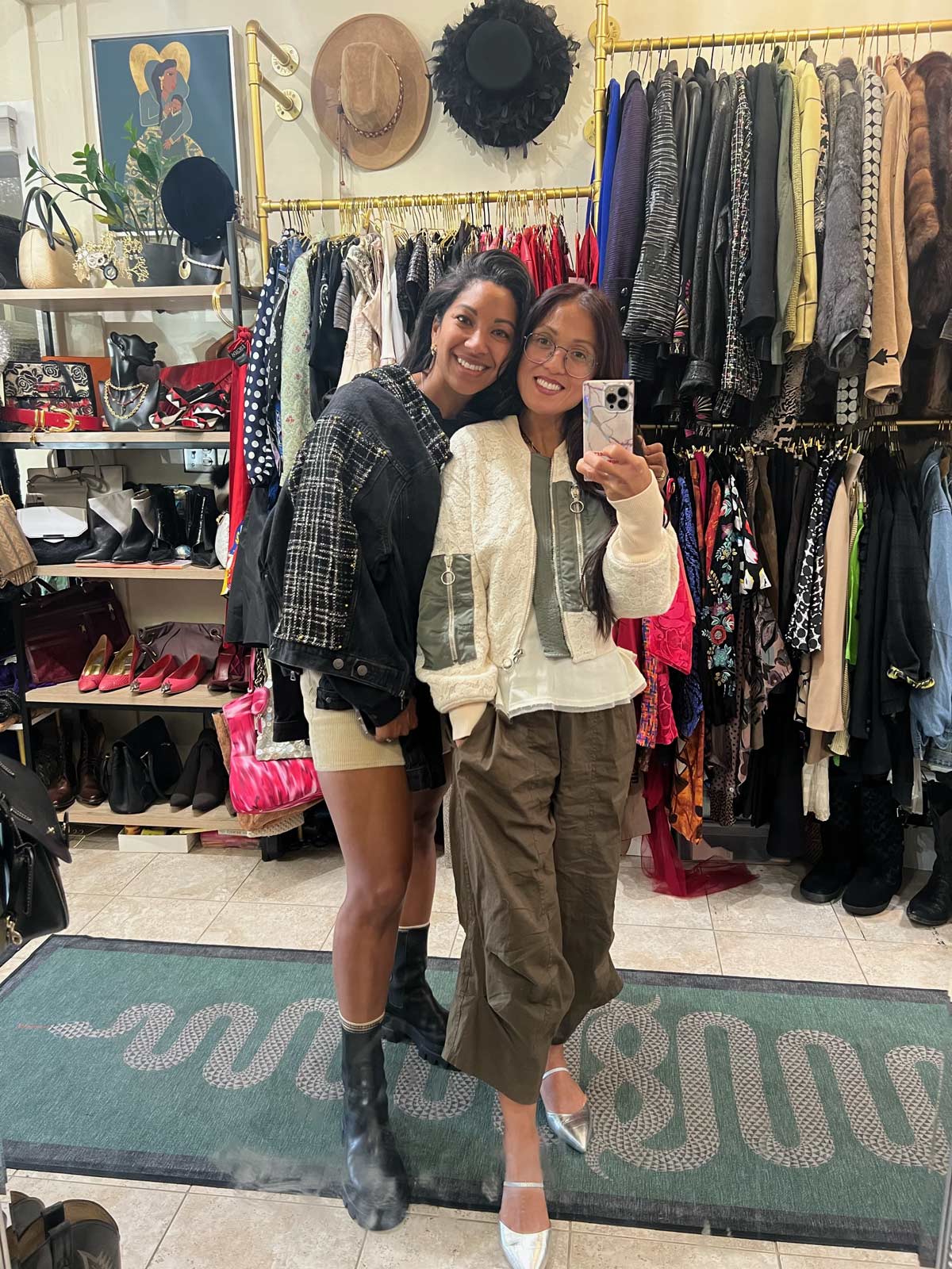 two women posing for a mirror selfie in sainted goods
