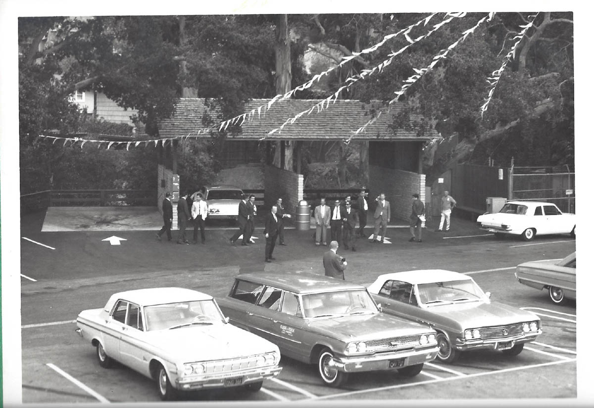 Vintage black and white photo of Carlmont Village Shopping Center with men in suits